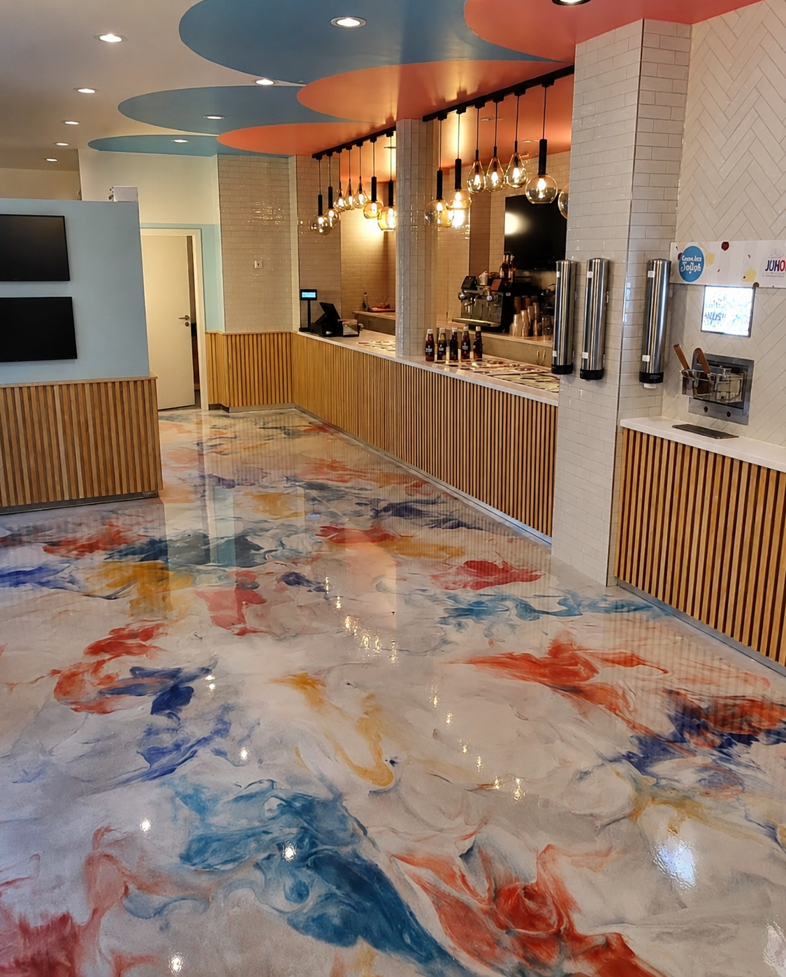 Colorful marbled epoxy floor in a commercial frozen yogurt shop