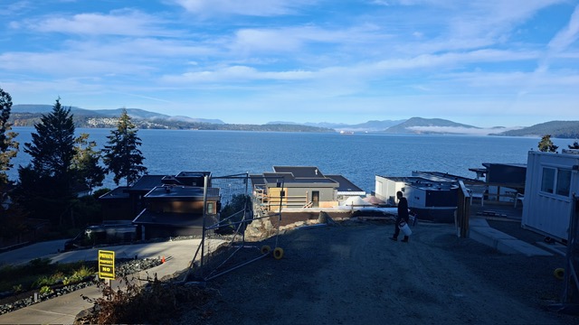 Waterfront custom home site in Lands End where a garage and mechanical rooms are being coated