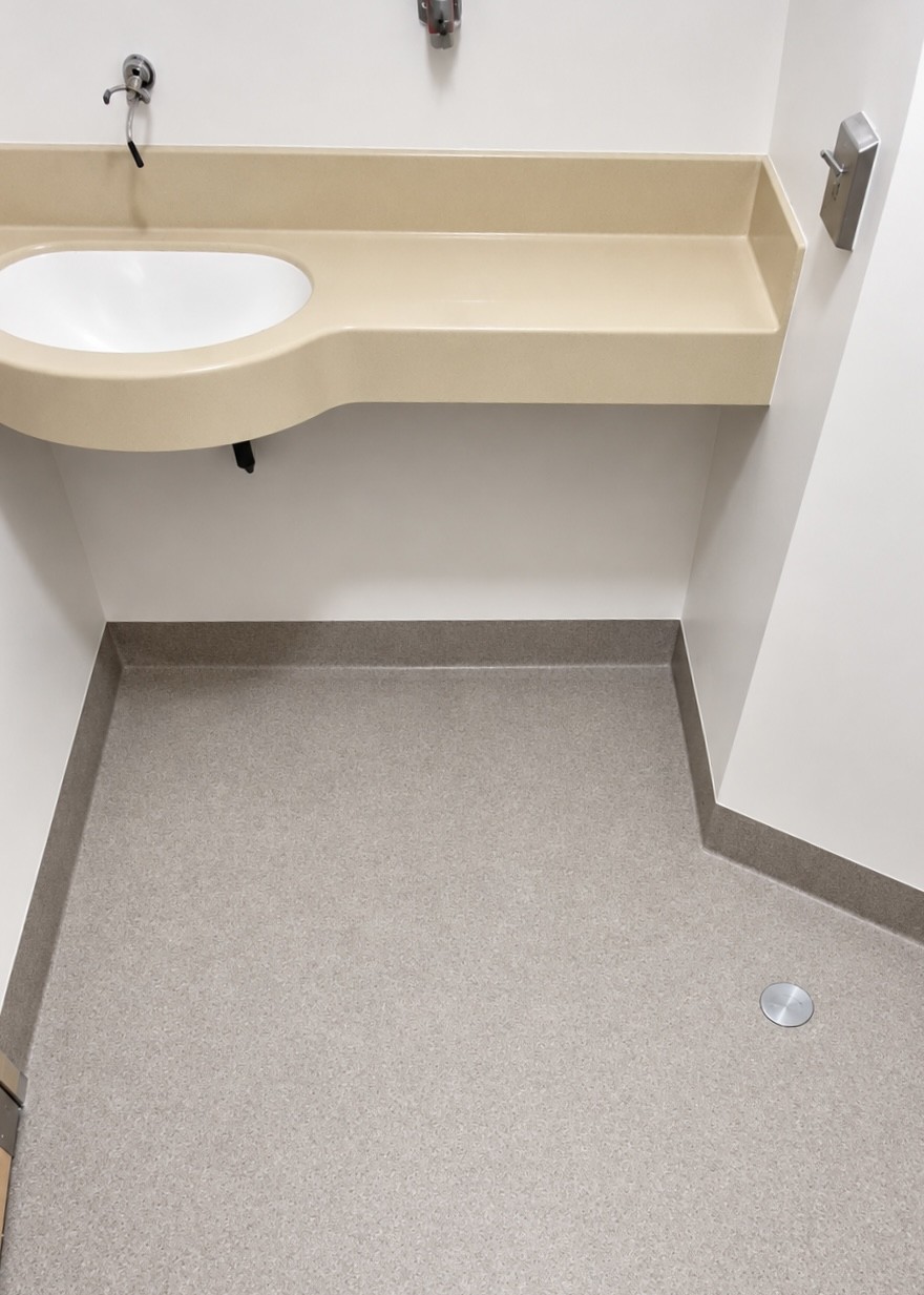 Speckled bathroom floor with a sink and coved base for the Vancouver Island Health Authority